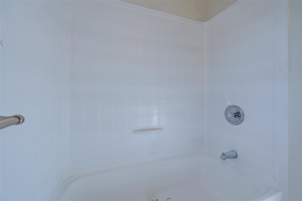 720 Jupiter Avenue Granbury, TX 76049 - Photo 13 of 23 a bathroom with a shower