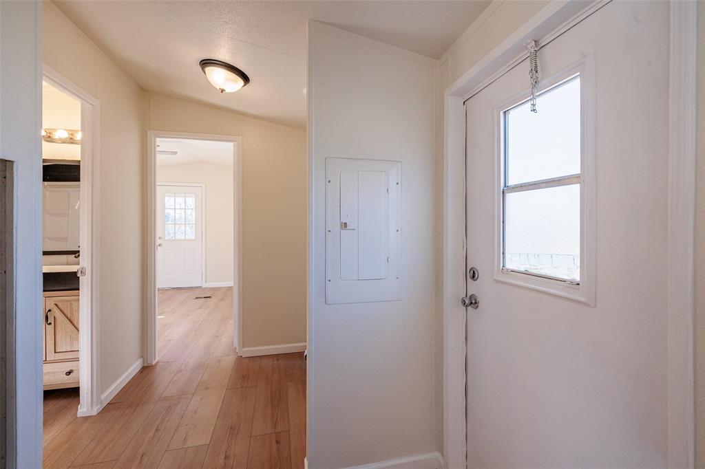 720 Jupiter Avenue Granbury, TX 76049 - Photo 15 of 23 a view of hallway with bathroom and wooden floor