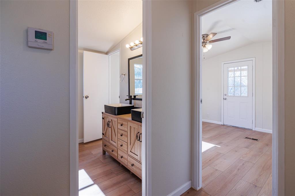 720 Jupiter Avenue Granbury, TX 76049 - Photo 16 of 23 a view of a kitchen from the hallway