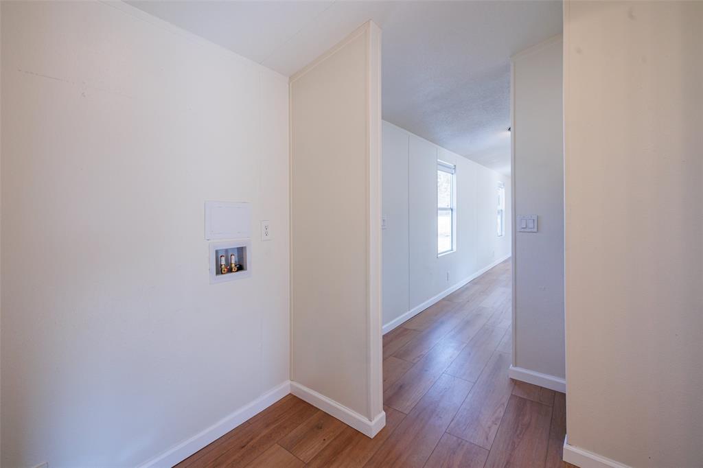 720 Jupiter Avenue Granbury, TX 76049 - Photo 17 of 23 a view of a hallway with wooden floor