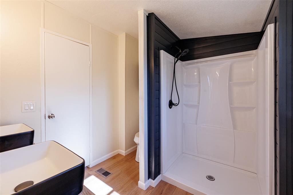 720 Jupiter Avenue Granbury, TX 76049 - Photo 20 of 23 a bathroom with a shower and a sink