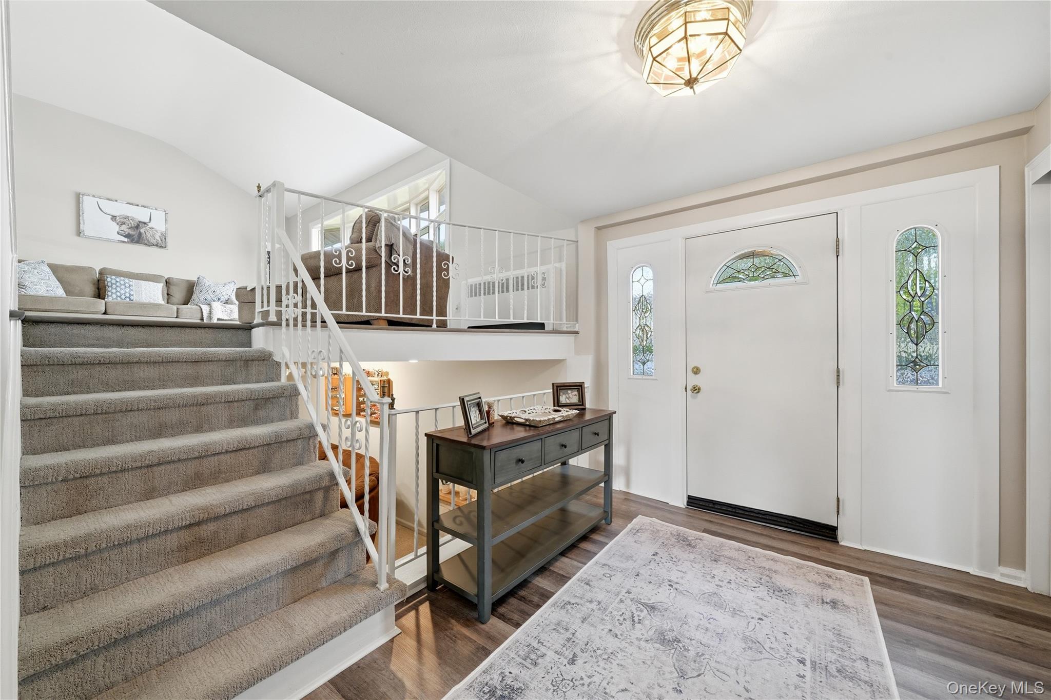 1853 Decatur Avenue Merrick, NY 11566 - Photo 11 of 43 a view of staircase with white walls and a chandelier