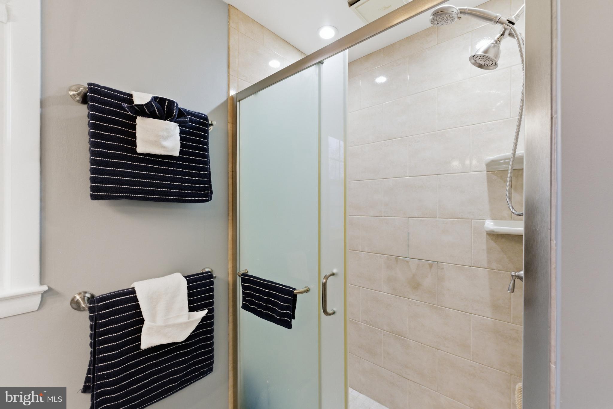 6124 Crozet Court Springfield, VA 22150 - Photo 21 of 57 a bathroom with a shower and a mirror