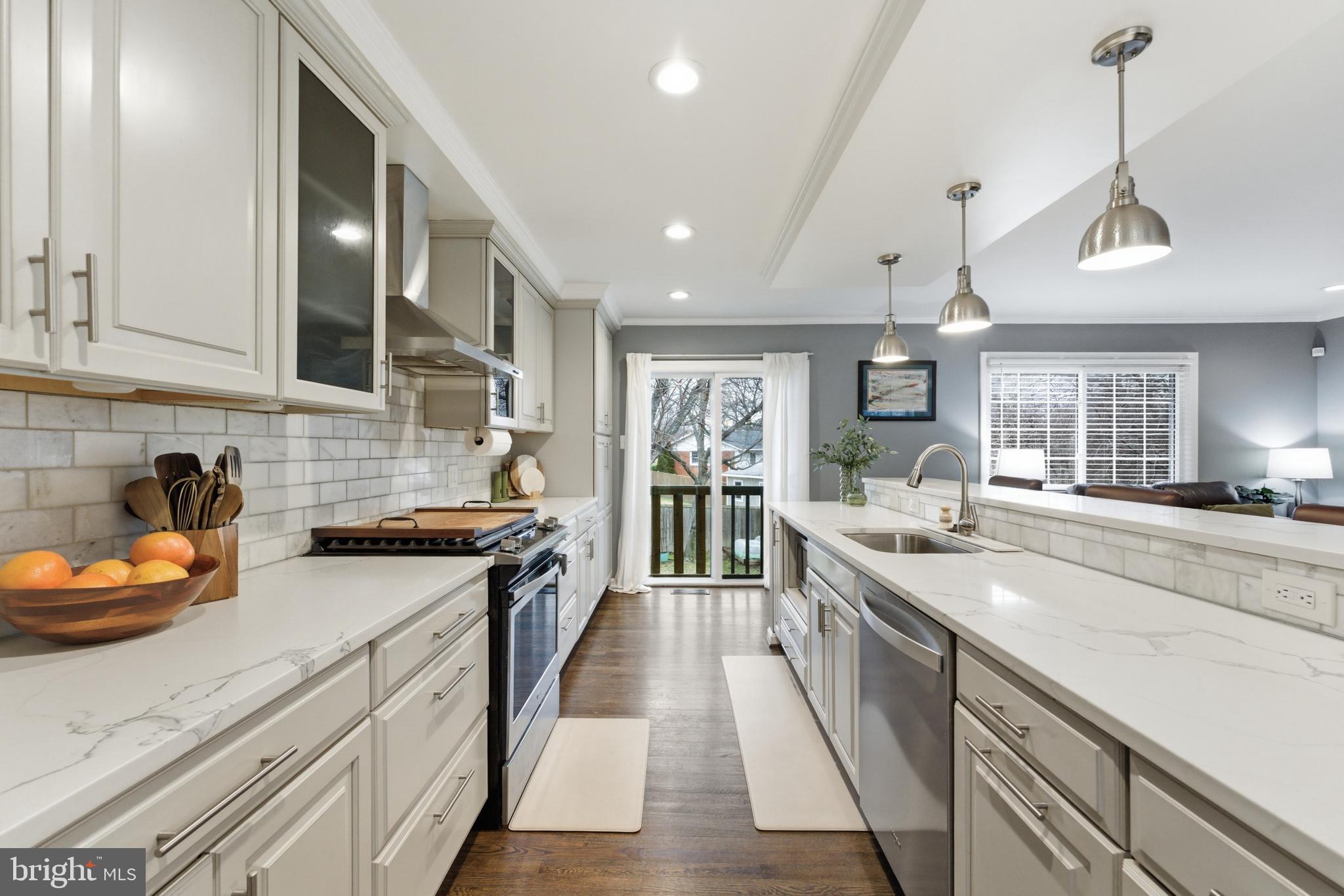 6124 Crozet Court Springfield, VA 22150 - Photo 5 of 57 a large kitchen with stainless steel appliances granite countertop a lot of counter space and wooden floors