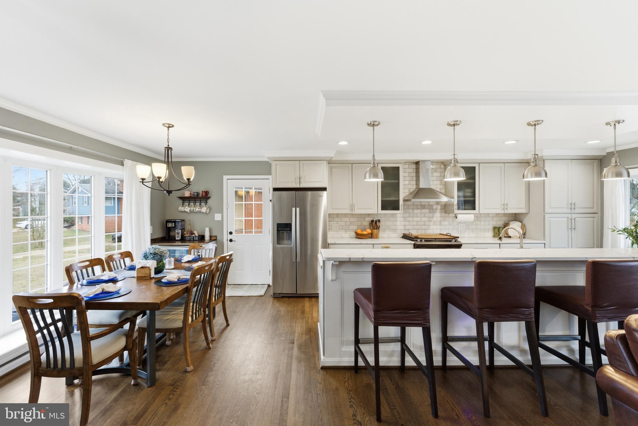 6124 Crozet Court Springfield, VA 22150 - Photo 8 of 57 a kitchen with a dining table chairs and refrigerator