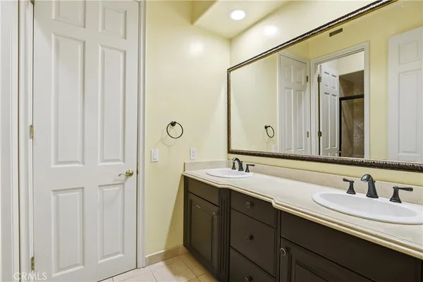 a bathroom with a double vanity sink and a mirror