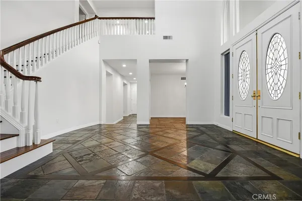 a view of a hallway with wooden floor and entryway