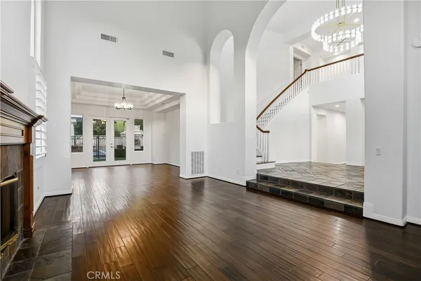 a view of a room with wooden floor and windows