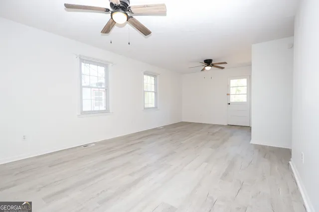 wooden floor in an empty room with a window