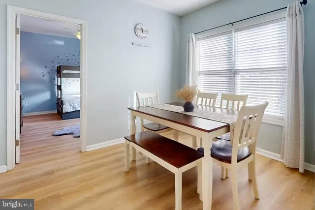 a dining room with furniture and wooden floor