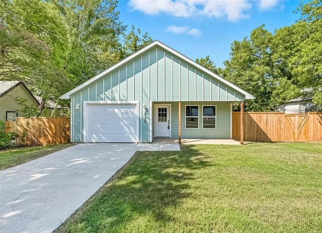 a view of a house with a yard and garage
