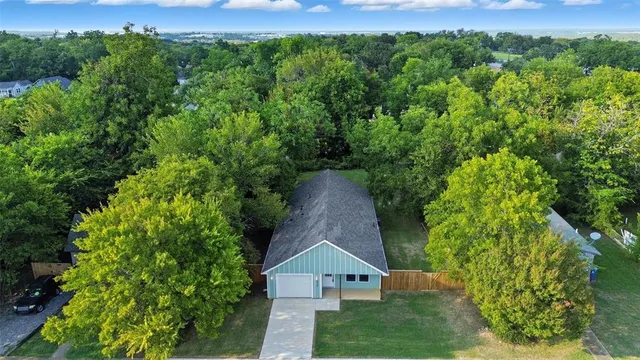 an aerial view of a house with a yard
