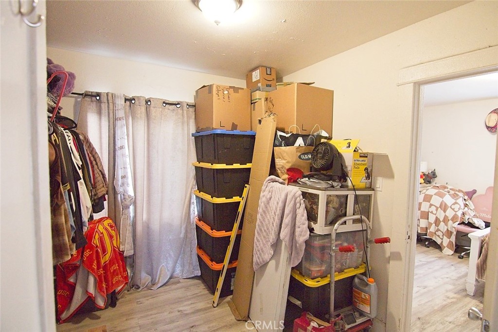 6905 Compton Avenue Los Angeles, CA 90001 - Photo 19 of 26 a view of walk in closet with clothes and shoes