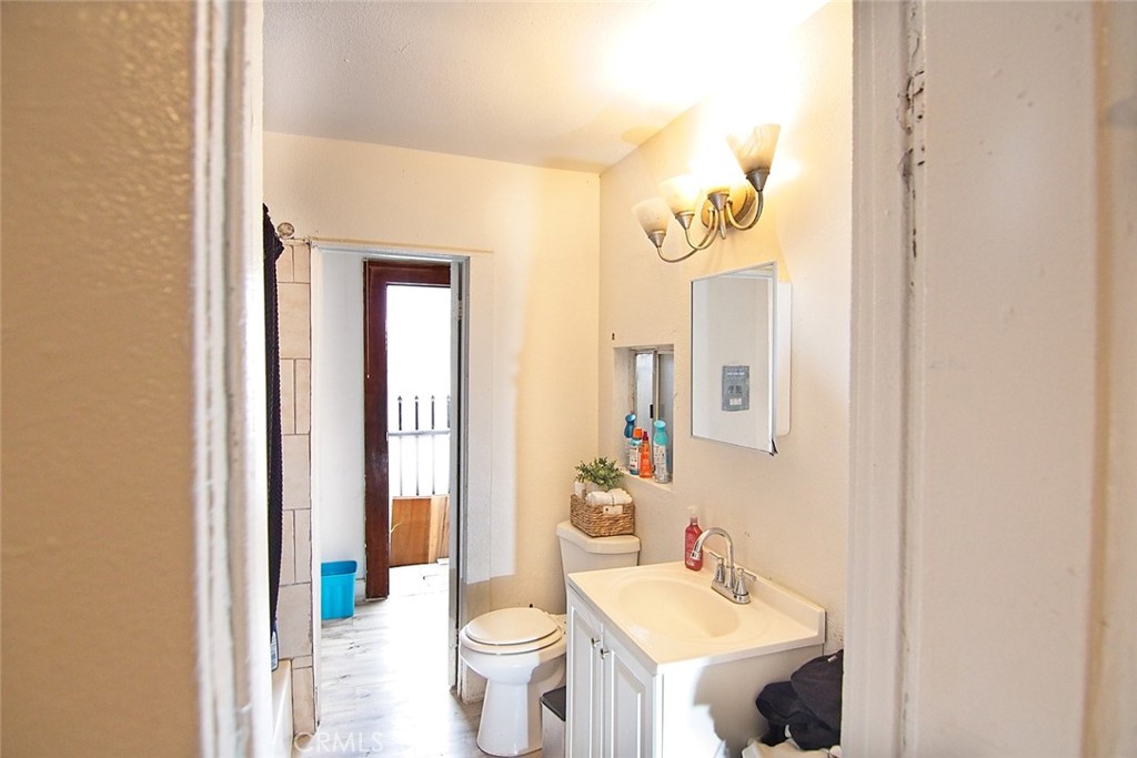 6905 Compton Avenue Los Angeles, CA 90001 - Photo 20 of 26 a bathroom with a sink and mirror with toilet