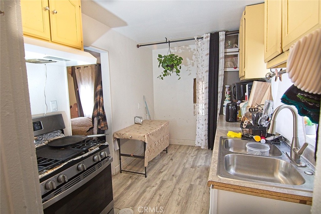 6905 Compton Avenue Los Angeles, CA 90001 - Photo 21 of 26 a kitchen with stainless steel appliances granite countertop a sink stove and cabinets