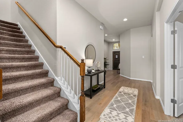 a view of entryway and hall with wooden floor