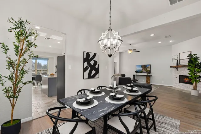a view of a dining room with furniture wooden floor and chandelier