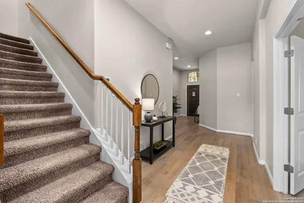 a view of entryway and hall with wooden floor