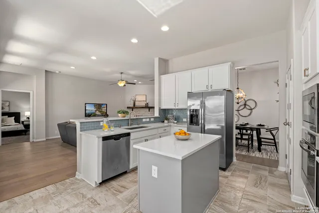 a kitchen with refrigerator and cabinets