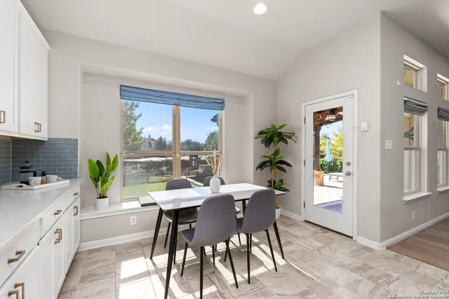 a kitchen with a table chairs and window