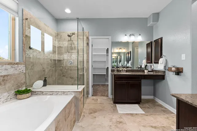 a bathroom with a sink double vanity and a shower