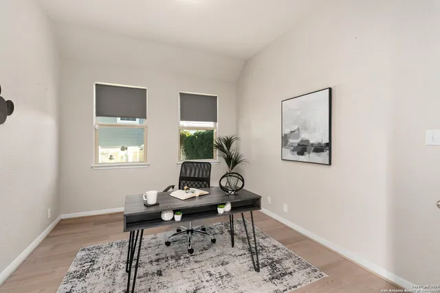 a living room with furniture a rug and a window