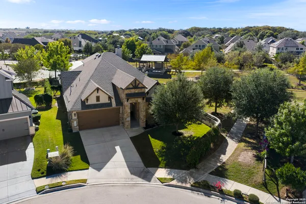 an aerial view of a house with yard swimming pool and outdoor seating