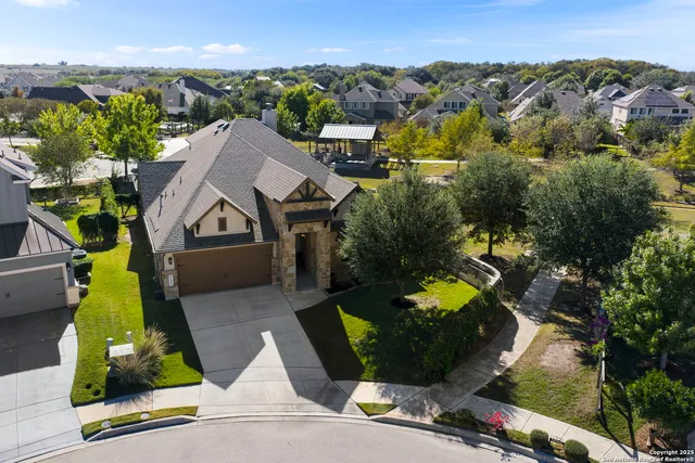 an aerial view of a house with yard swimming pool and outdoor seating
