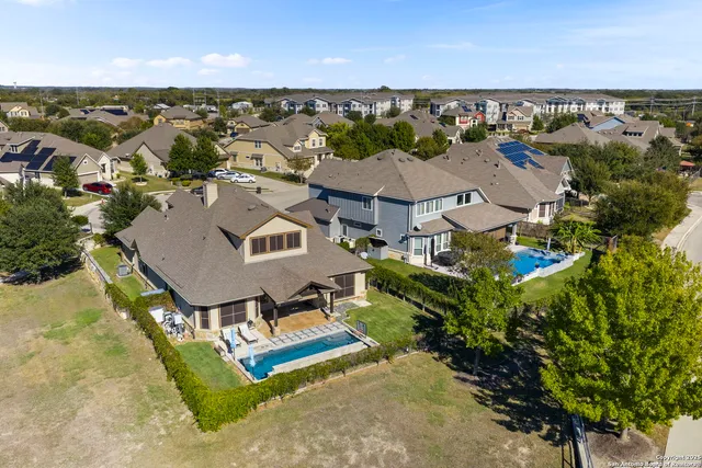 an aerial view of a house with garden space and outdoor seating