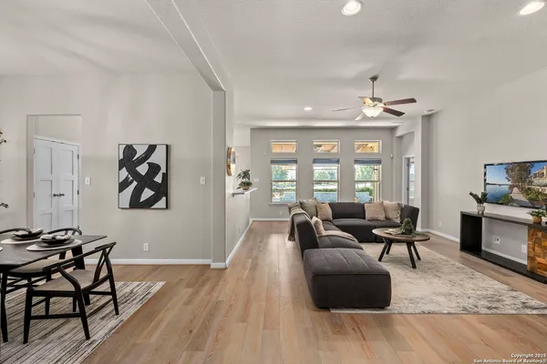 a living room with furniture and wooden floor