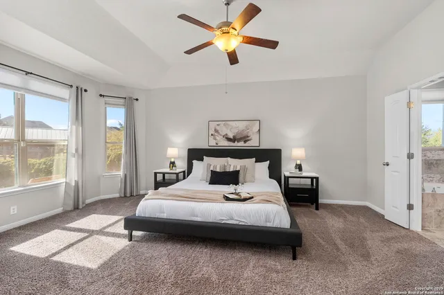 a bedroom with a bed and a large window