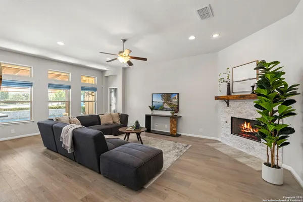 a living room with furniture a potted plant and a chandelier