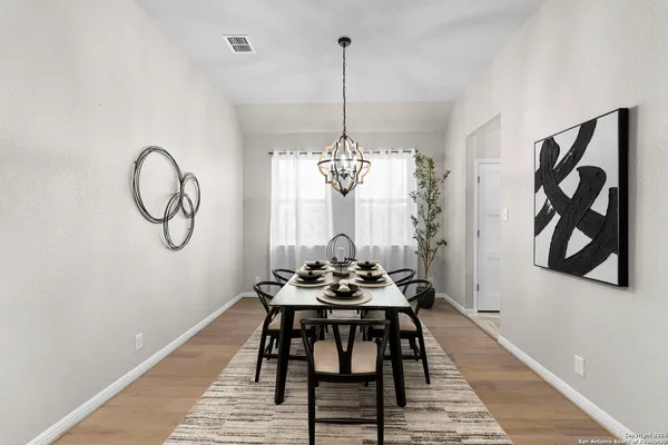 a dining room with furniture and window
