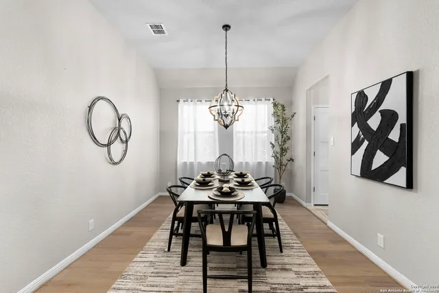 a dining room with furniture and window