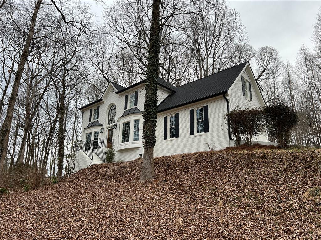 935 Steeplechase Road Alpharetta, GA 30004 - Photo 1 of 1 a front view of a house with a yard