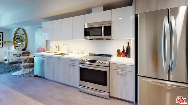 a kitchen with stainless steel appliances granite countertop a refrigerator stove and sink