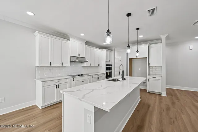 a open kitchen with kitchen island a sink stainless steel appliances and cabinets