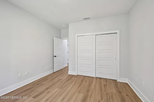 a view of wooden floor and windows in an empty room