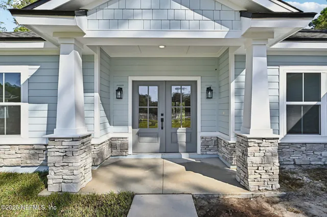 a view of a hallway with wooden floor and a kitchen
