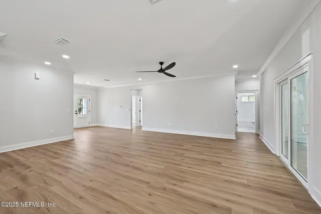 a view of a kitchen with stainless steel appliances granite countertop wooden floors and a fireplace