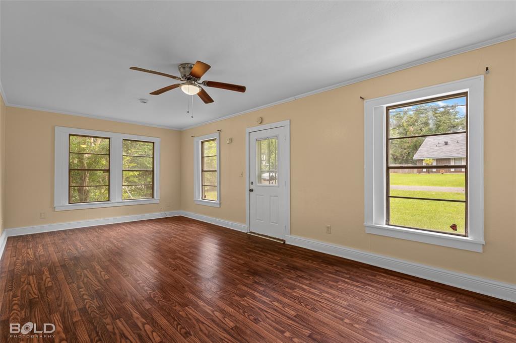 115 Pam Street Mansfield, LA 71052 - Photo 7 of 25 a view of empty room with wooden floor and fan