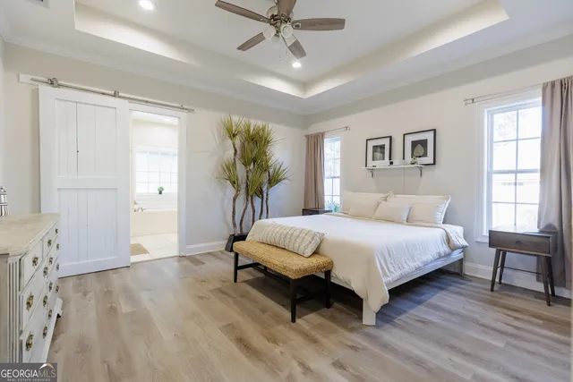 a bedroom with a large bed and a window