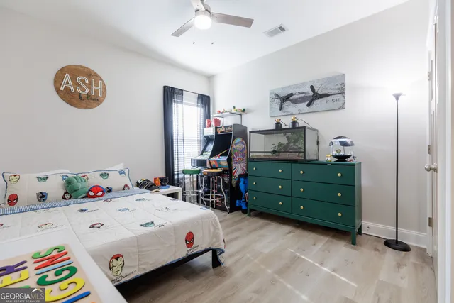 a bathroom with a granite countertop sink a toilet and a mirror