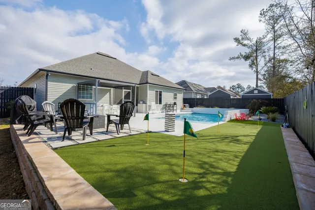 a front view of house with yard patio and seating area