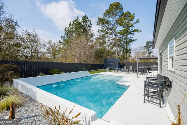a view of a patio with table and chairs