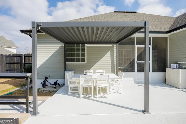 a front view of a house with garden and sitting area