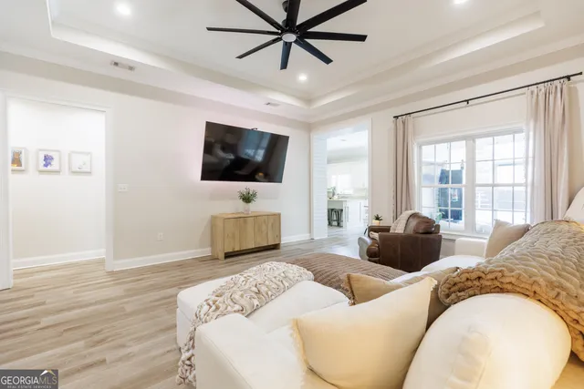 a living room with furniture and a chandelier