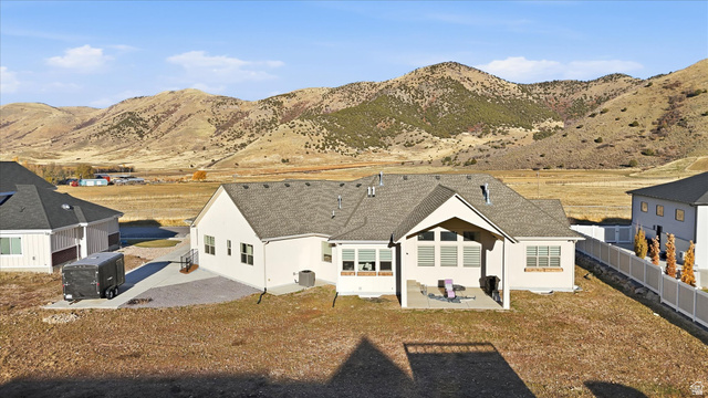 534 East Fish Hatchery Road Mantua, UT 84324 - Photo 68 of 87 Back of property with a patio area, stucco siding, a mountain view, and roof with shingles