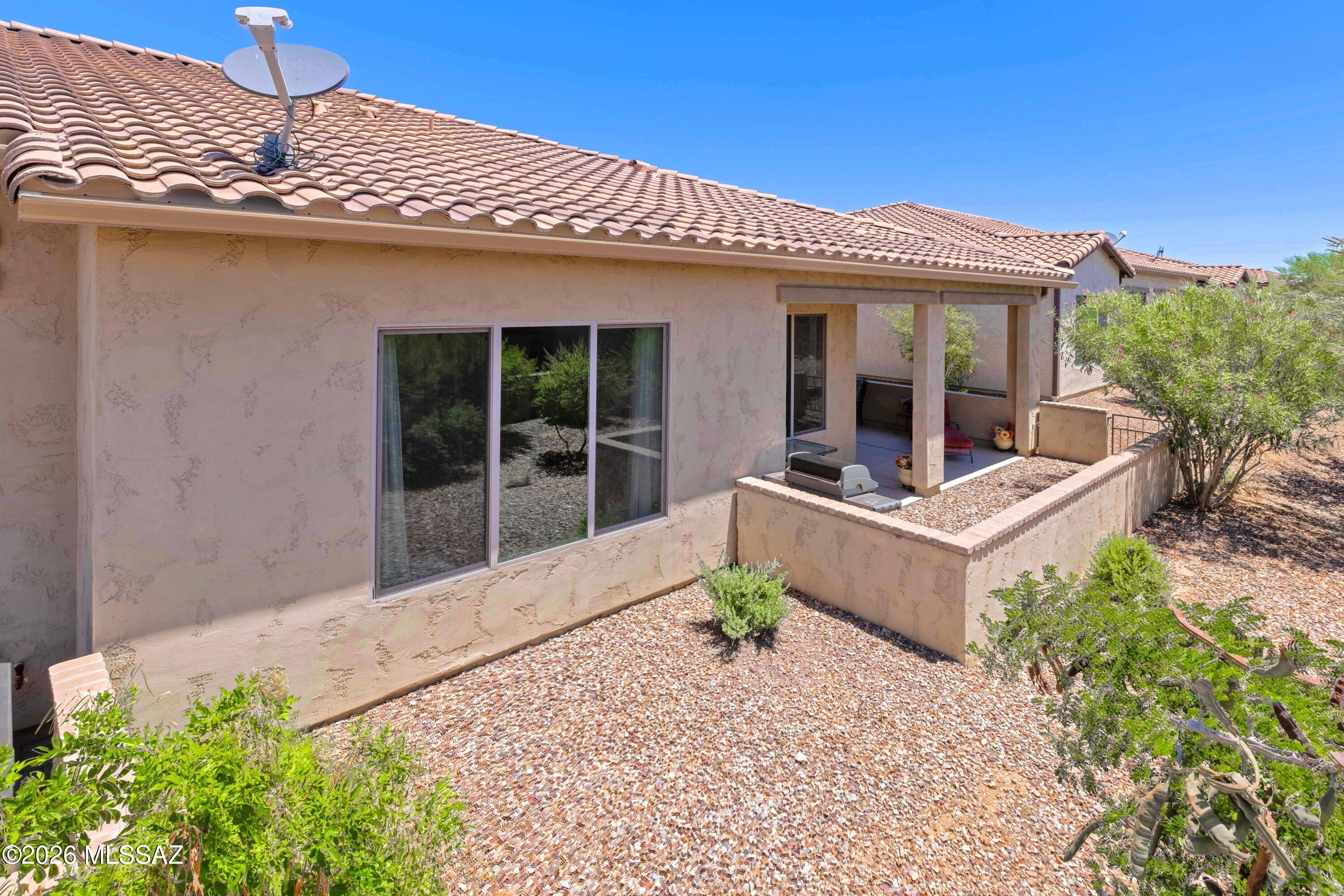 61193 East Shale Road Oracle, AZ 85623 - Photo 33 of 50 a front view of a house with garden