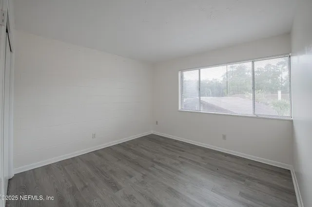 an empty room with wooden floor